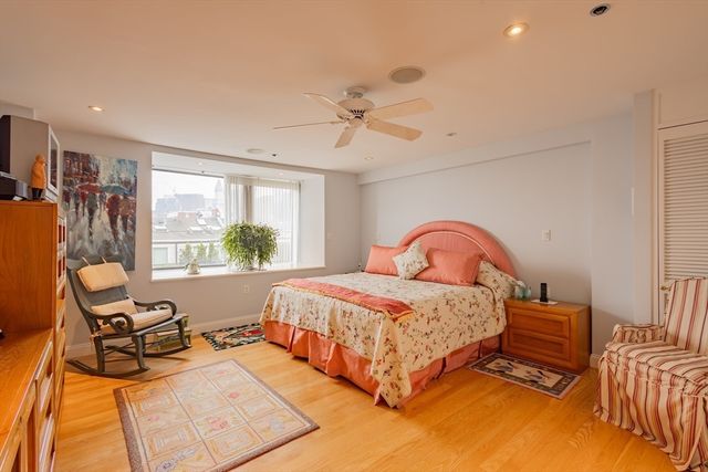 a bedroom with a bed and glass walk in closet