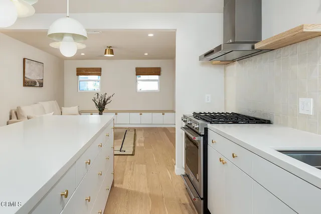 a kitchen with a sink dishwasher a stove and a refrigerator with wooden floor