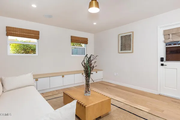 a living room with furniture and a potted plant