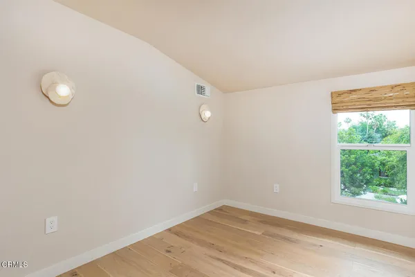 a view of a small space with wooden floor and windows