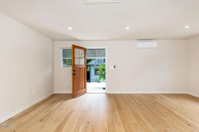 wooden floor in an empty room with a window
