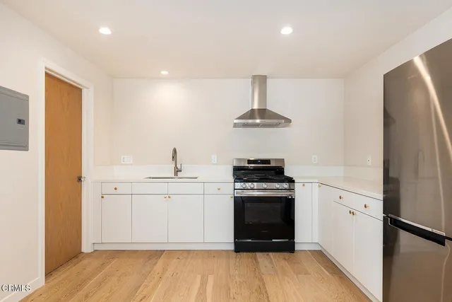 a kitchen with a sink stainless steel appliances and cabinets
