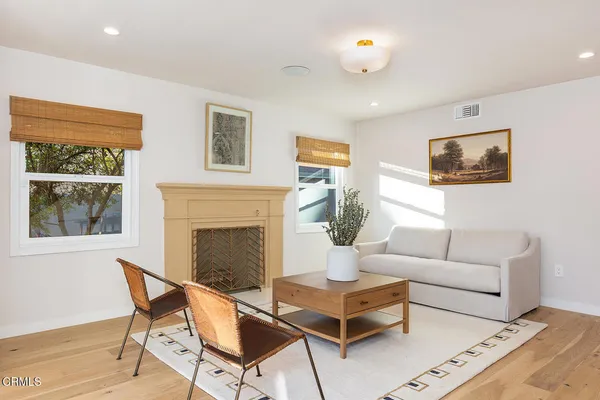 a living room with furniture a fireplace and a flat screen tv