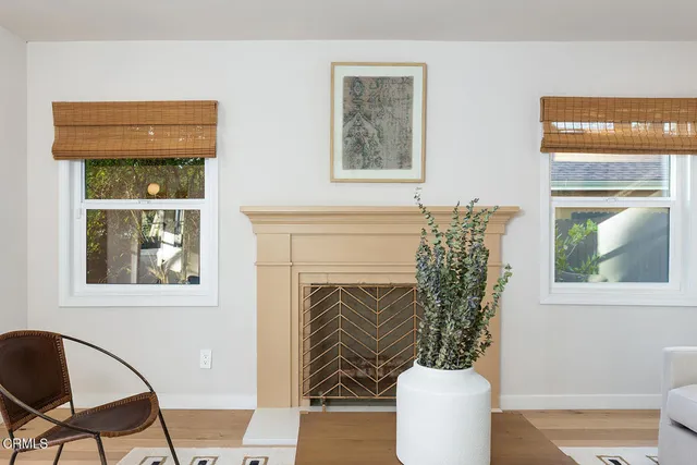 a living room with a fireplace and a window