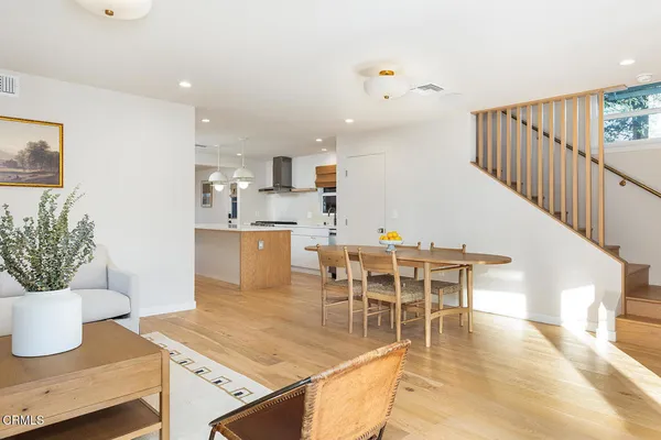 a view of a dining room with furniture and wooden floor