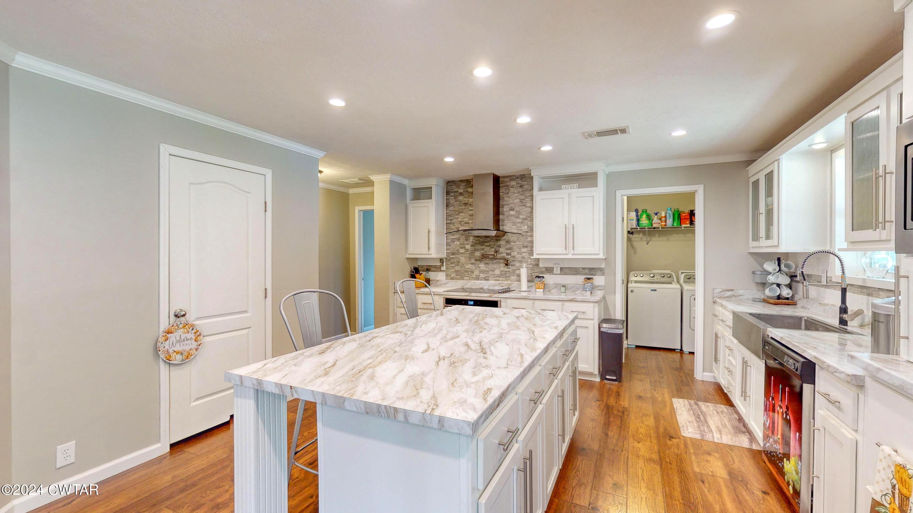 32 Jim Jackson Road Humboldt, TN 38343 - Photo 14 of 35 a large kitchen with stainless steel appliances lots of counter space and wooden floor