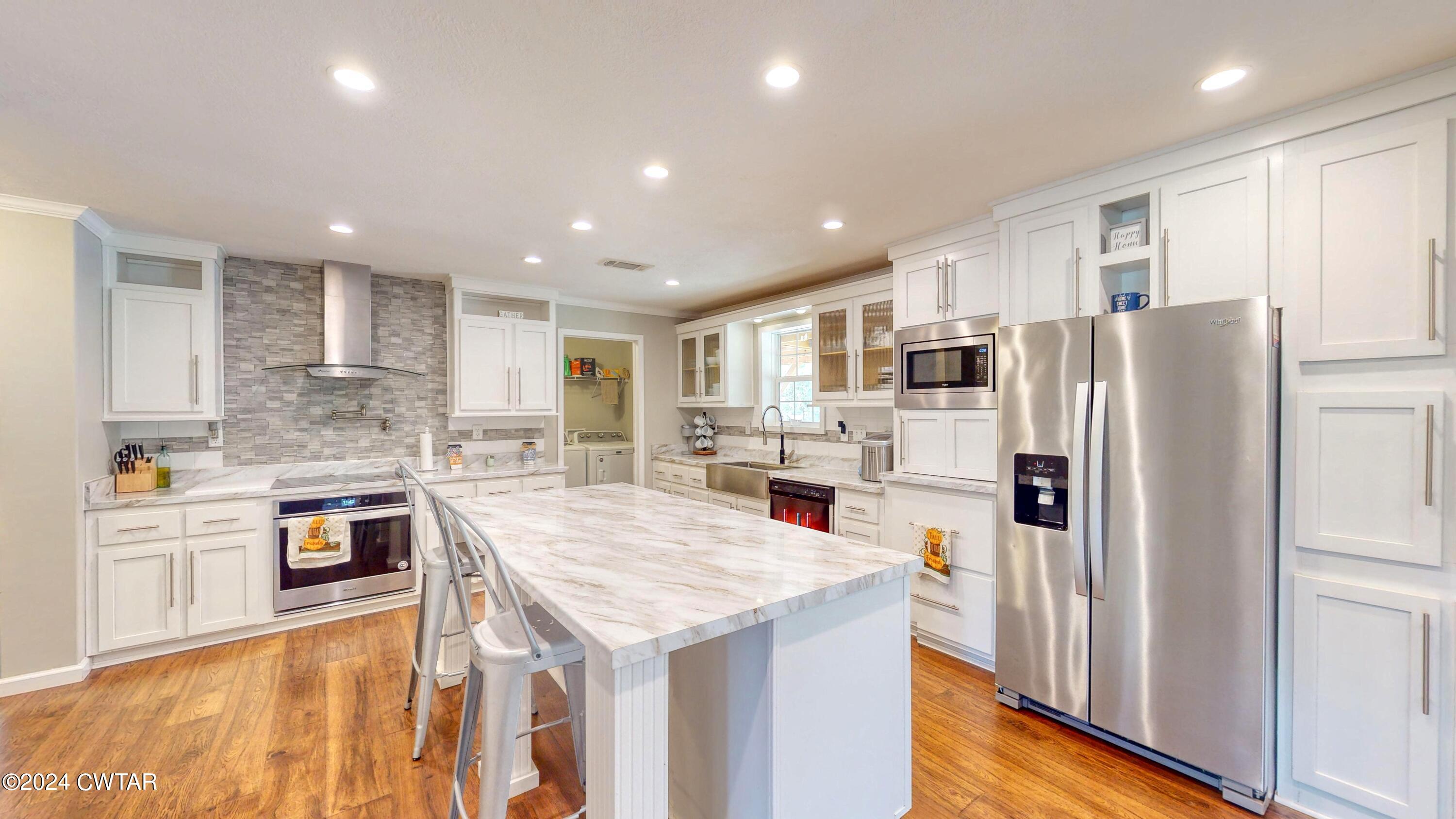 32 Jim Jackson Road Humboldt, TN 38343 - Photo 16 of 35 a kitchen with stainless steel appliances granite countertop a refrigerator and a stove top oven
