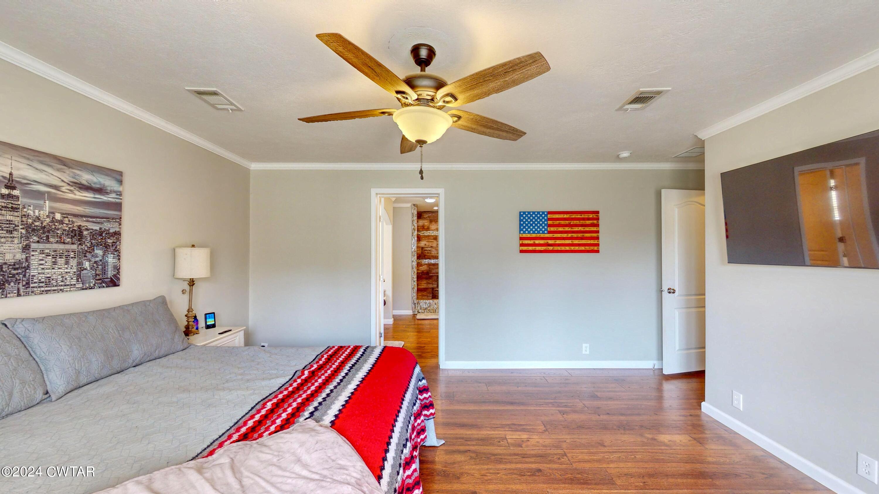 32 Jim Jackson Road Humboldt, TN 38343 - Photo 18 of 35 a bedroom with a bed and a chandelier