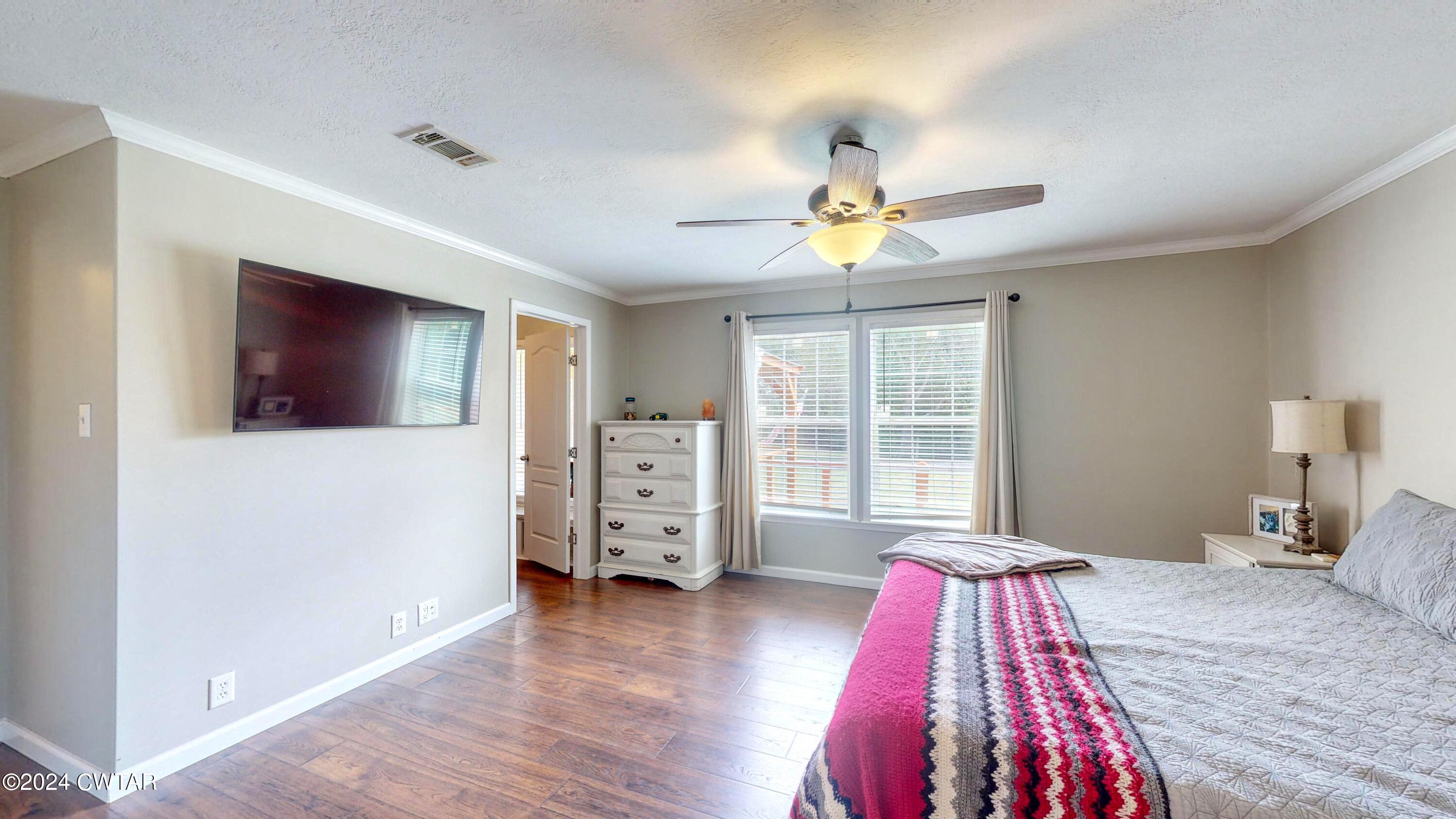 32 Jim Jackson Road Humboldt, TN 38343 - Photo 20 of 35 a bedroom with a bed and wooden floor