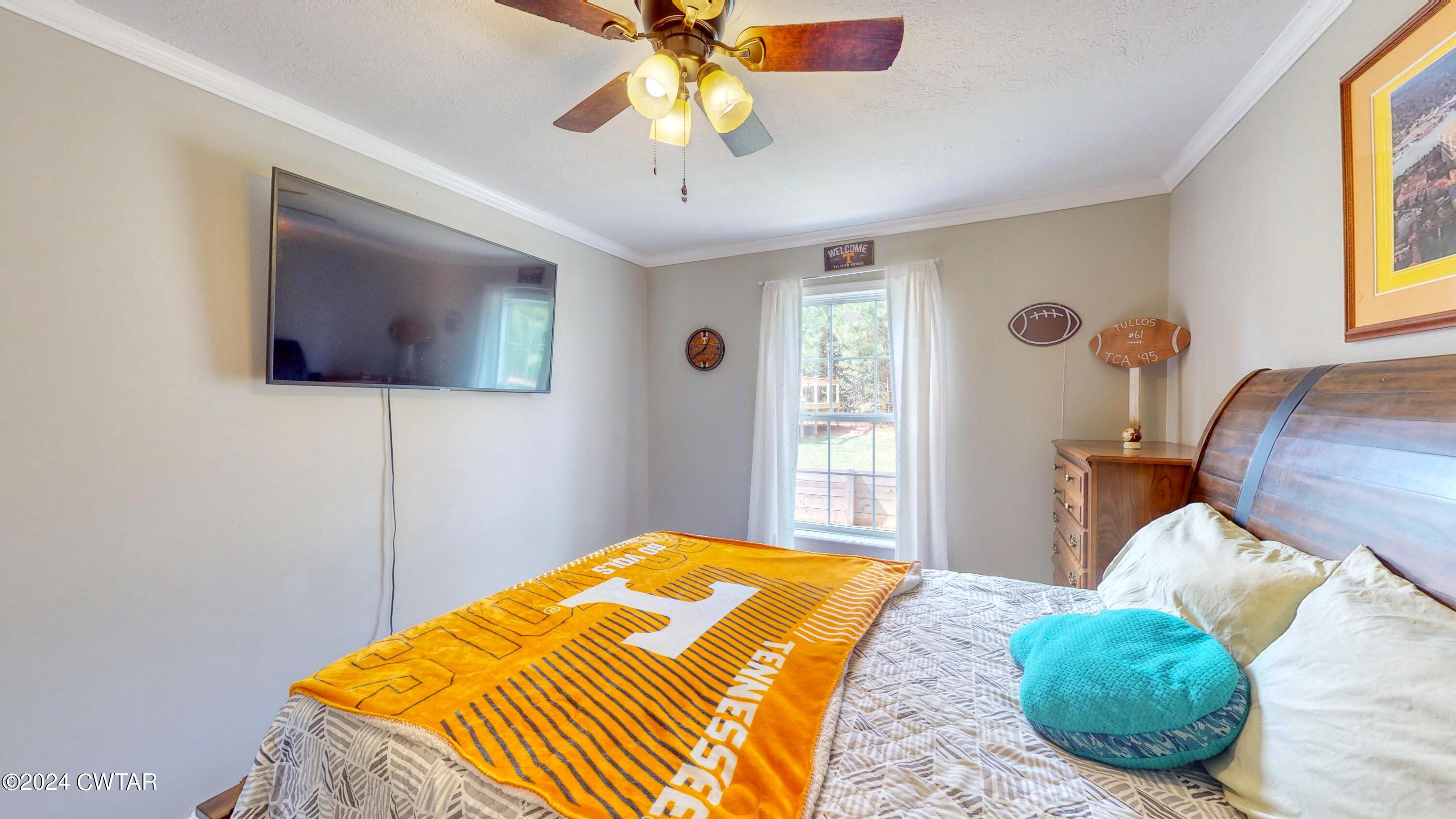 32 Jim Jackson Road Humboldt, TN 38343 - Photo 24 of 35 a bedroom with a bed and a chandelier