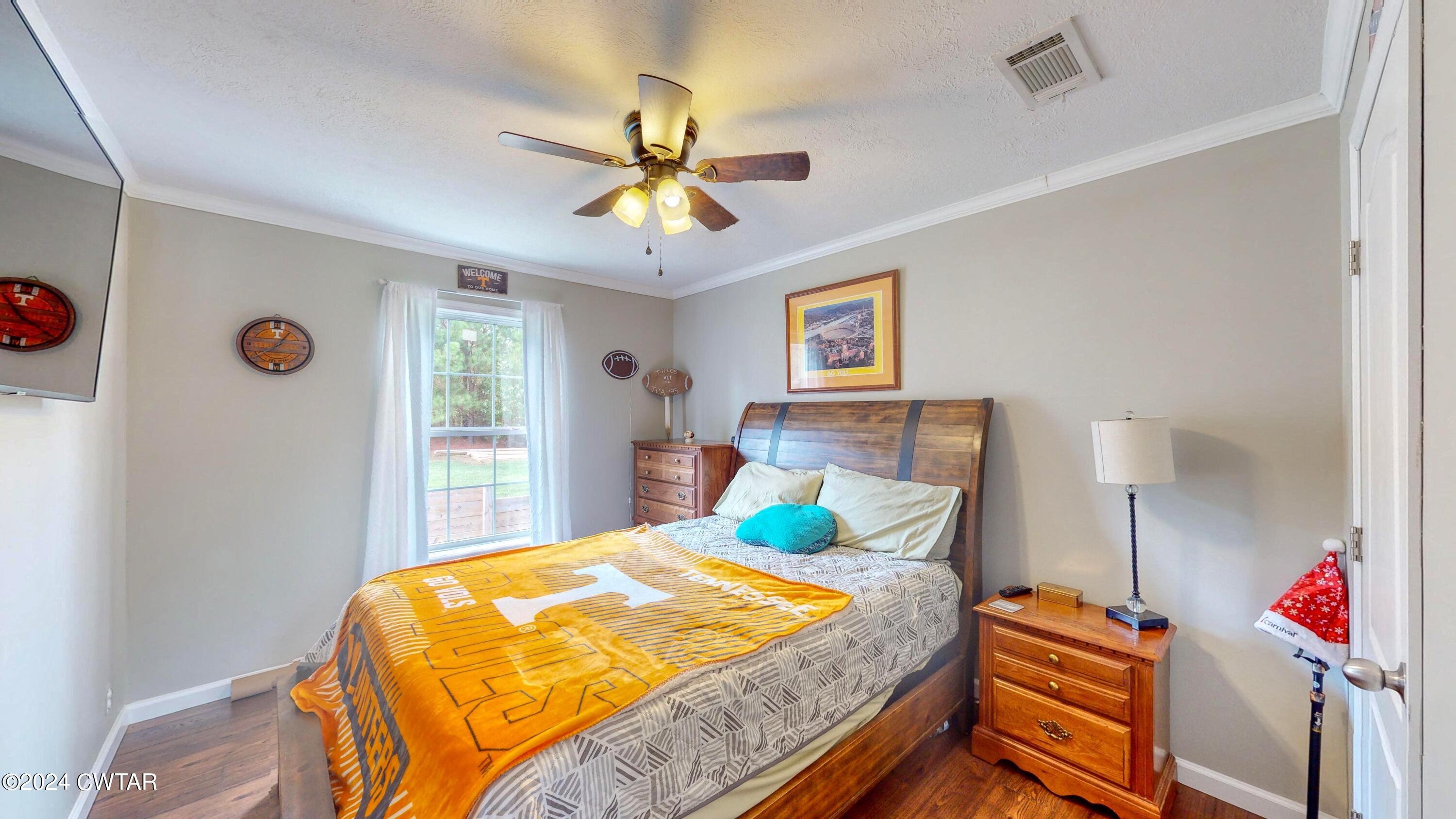 32 Jim Jackson Road Humboldt, TN 38343 - Photo 25 of 35 a bedroom with a bed and a chandelier