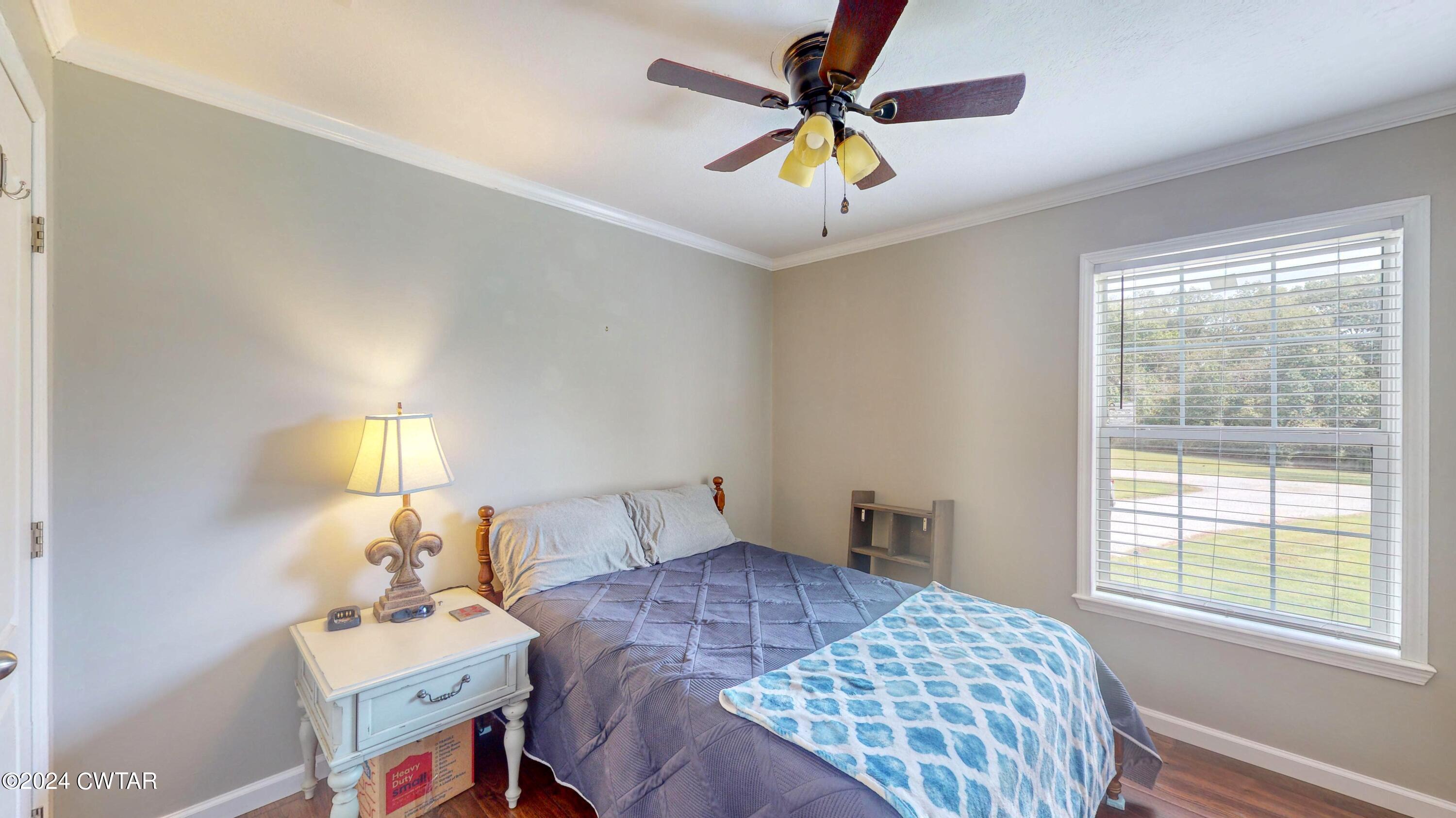 32 Jim Jackson Road Humboldt, TN 38343 - Photo 26 of 35 a bedroom with a bed and a chandelier