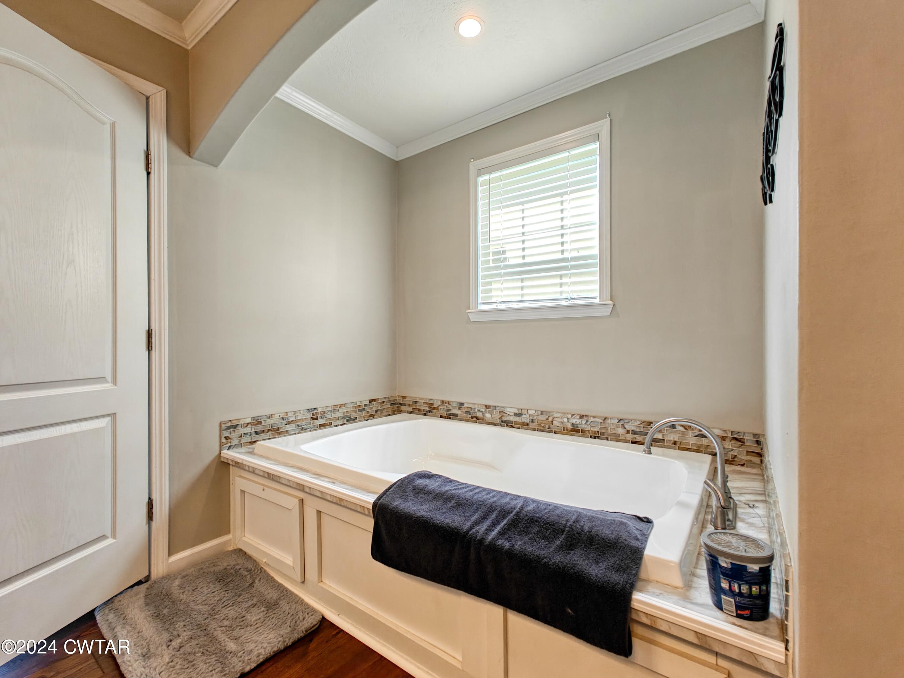 32 Jim Jackson Road Humboldt, TN 38343 - Photo 27 of 35 a white bath tub sitting in a bathroom next to a window