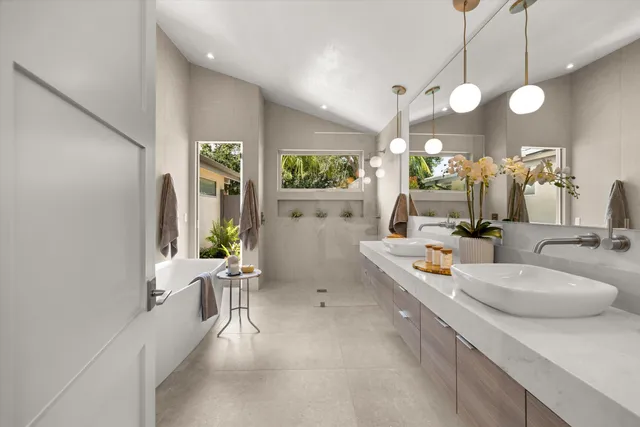 a white bath tub sitting in a bathroom next to a window