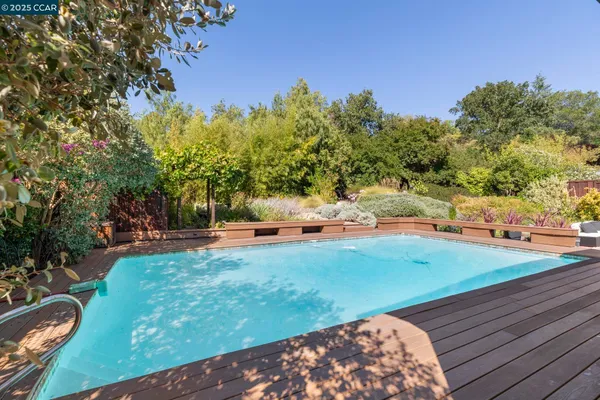 a backyard of a house with table and chairs