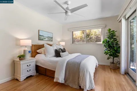 a bedroom with a bed and a potted plant