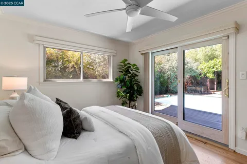 a bedroom with a large bed and a large window