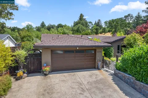 a view of a house with a garage and sitting area