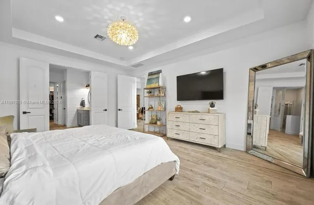 a bedroom with furniture and flat screen tv