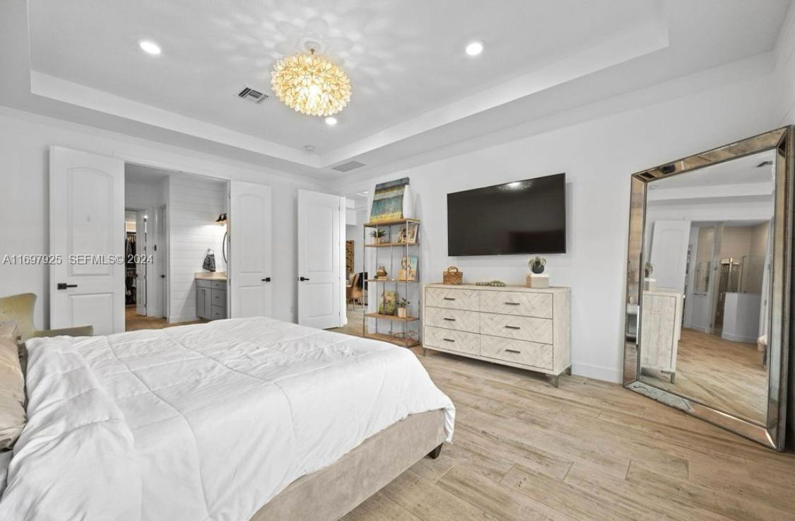 141 Cinder Dunes Point Jupiter, FL 33478 - Photo 16 of 35 a bedroom with furniture and flat screen tv