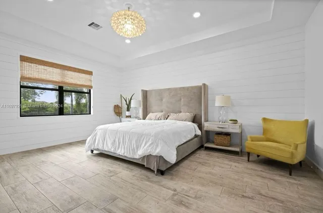 a spacious bedroom with a bed and a window