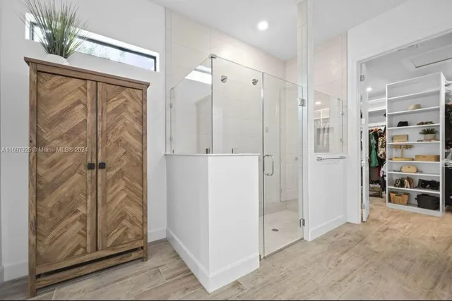 a view of a bathroom with a shower and closet