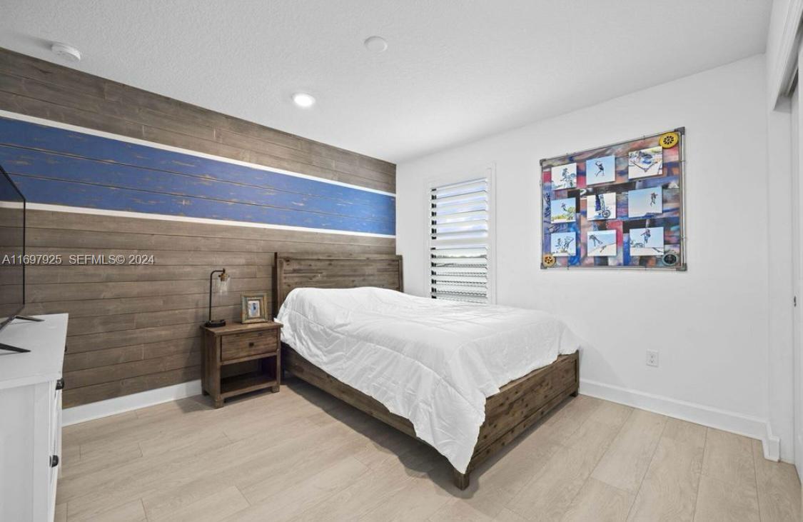 141 Cinder Dunes Point Jupiter, FL 33478 - Photo 20 of 35 a bedroom with a bed and a wall painting