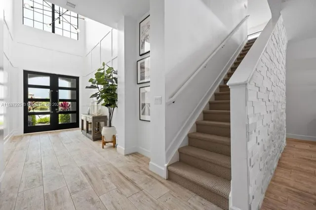 a view of entryway and hall with wooden floor