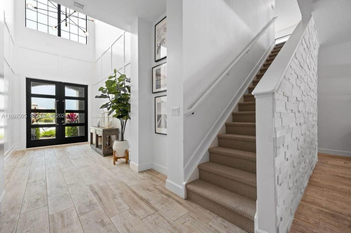 141 Cinder Dunes Point Jupiter, FL 33478 - Photo 21 of 35 a view of entryway and hall with wooden floor