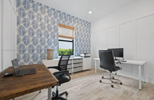 a view of a workspace with furniture and a window