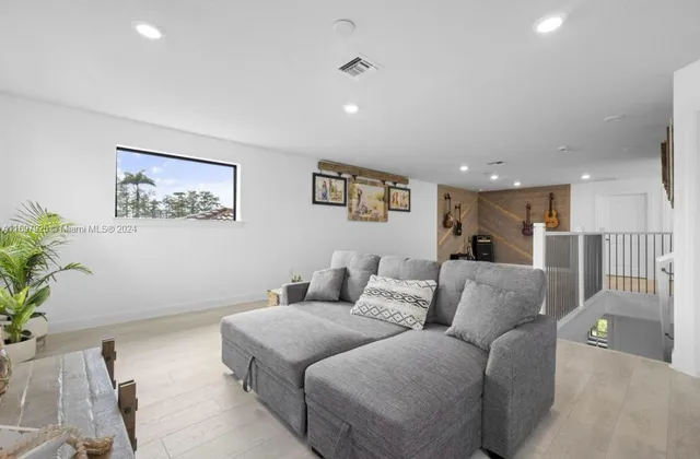 a living room with furniture and a potted plant