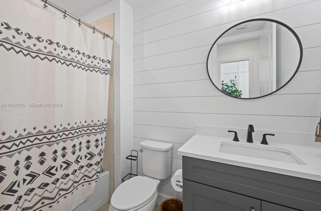 141 Cinder Dunes Point Jupiter, FL 33478 - Photo 25 of 35 a bathroom with a sink a toilet and a mirror