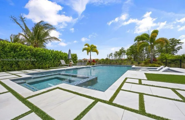 a view of swimming pool with outdoor seating and plants