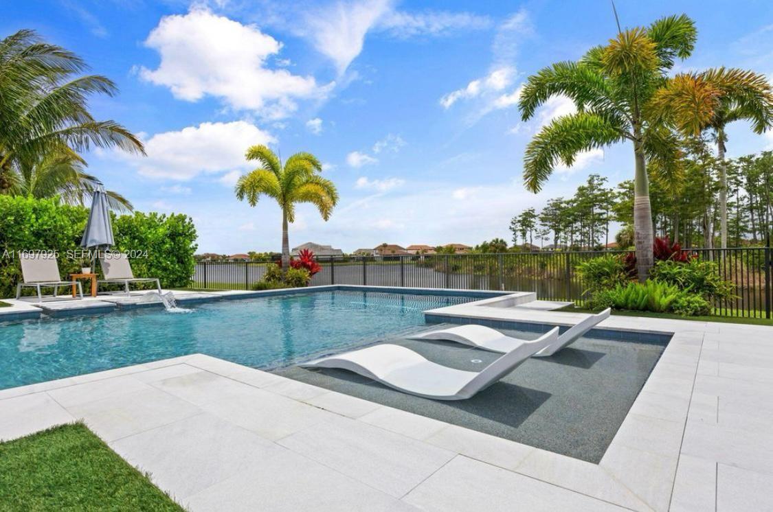 141 Cinder Dunes Point Jupiter, FL 33478 - Photo 28 of 35 a view of swimming pool with outdoor seating and plants