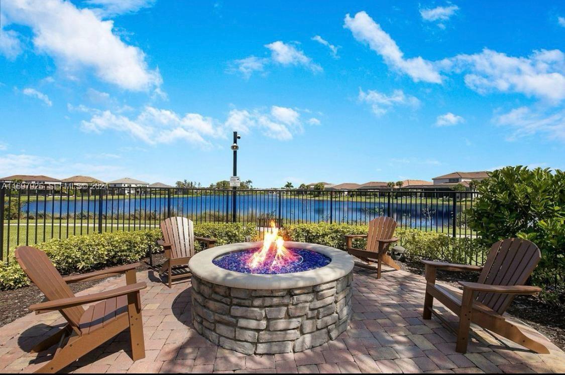 141 Cinder Dunes Point Jupiter, FL 33478 - Photo 34 of 35 a lake view with a seating space and hardwood floor