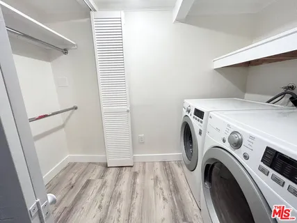 a view of storage and utility room with washer and dryer