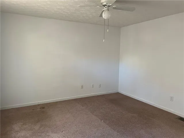 en empty room with a fan