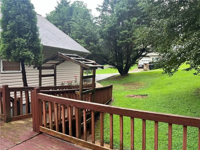 a view of a wooden deck and a yard
