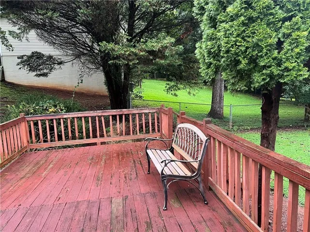 a view of a wooden deck with furniture