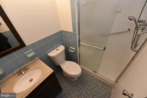 a white toilet sitting next to a bathroom sink and a tub