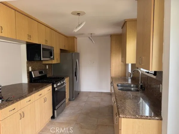 a kitchen with a sink appliances and cabinets