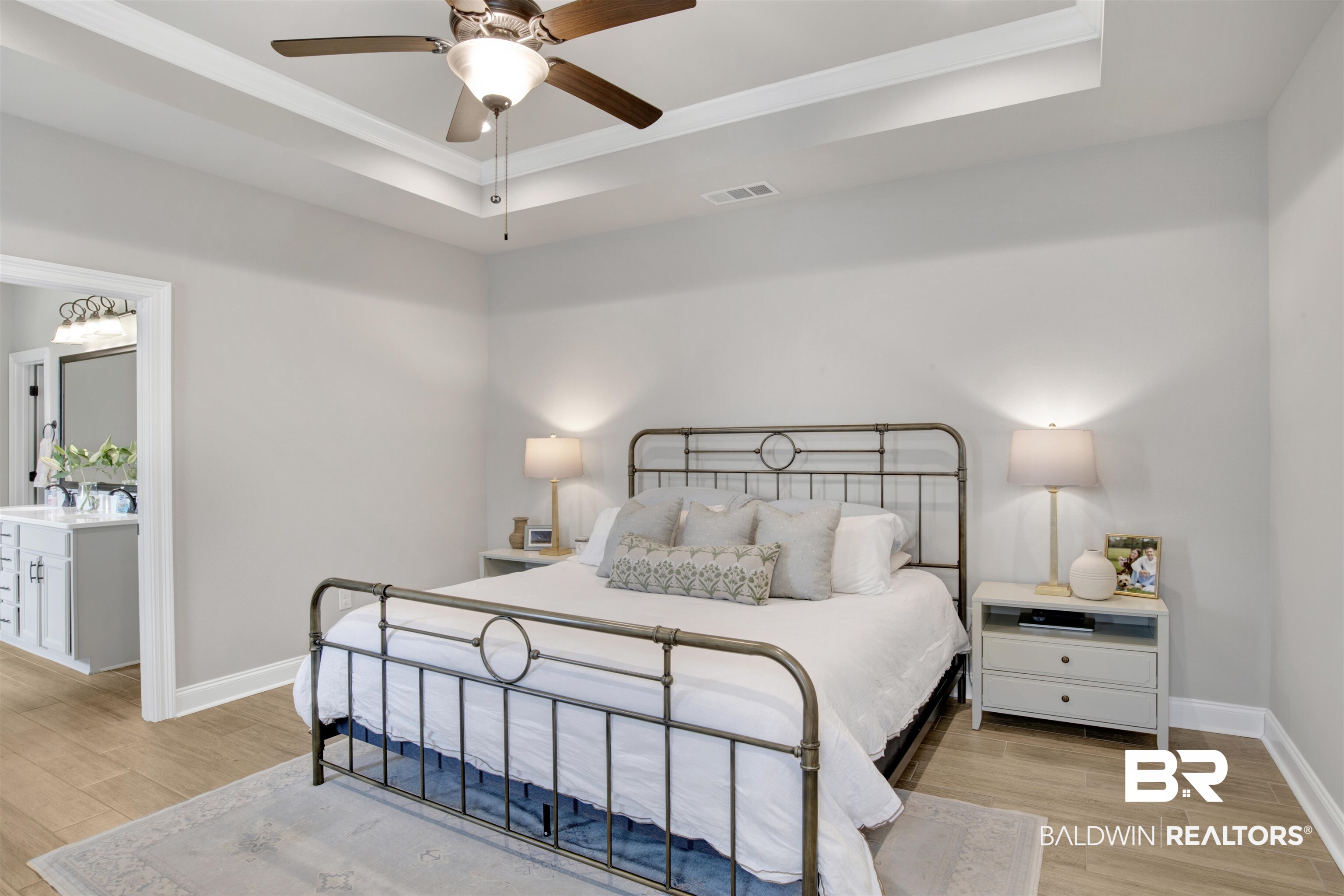 30770 Marcel Boulevard Spanish Fort, AL 36527 - Photo 13 of 23 Bedroom with light wood-type flooring, a raised ceiling, and ceiling fan