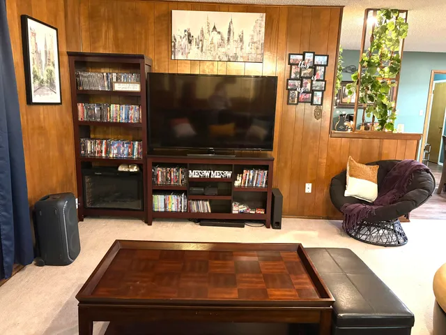 a room with furniture projector and screen