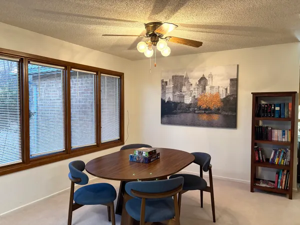 a view of a dining room with furniture and a potted plant