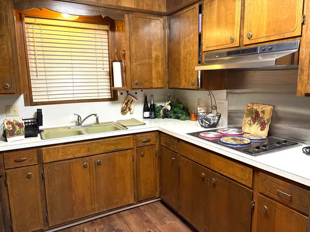 a kitchen with sink and cabinets