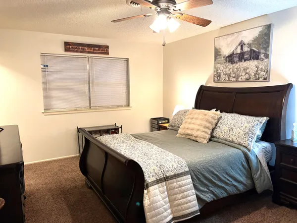 a bedroom with a bed and a painting on the wall