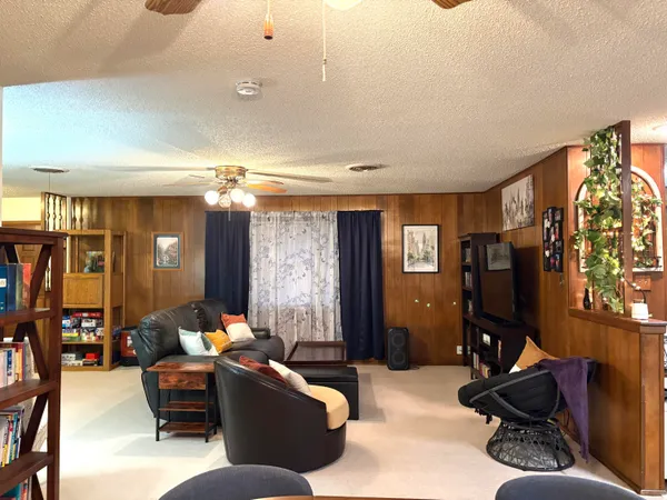 a living room with furniture gym equipment and a mirror