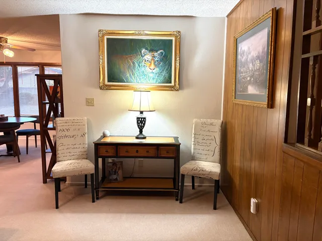 a living room with furniture and a painting on the wall