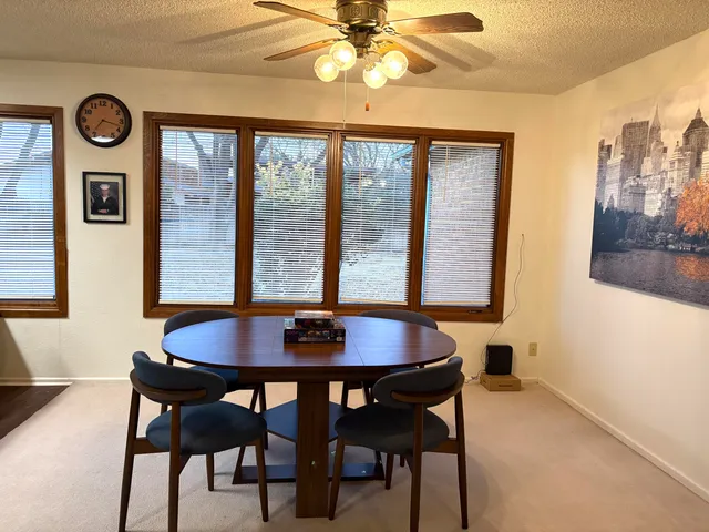 a dining room with furniture and window