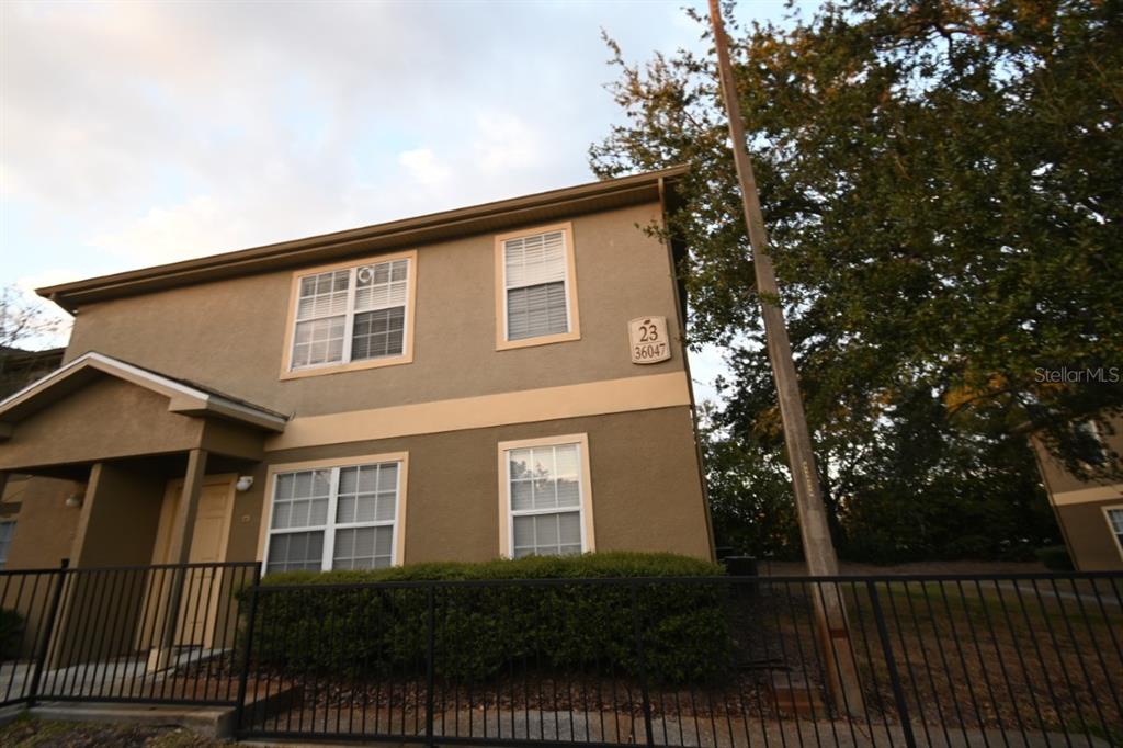 a front view of a house with iron fence
